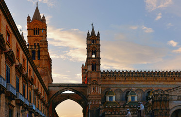 Wall Mural - Golden sunset light seen from street with gothic arch of cathedral of Palermo with towers in the old town of Palermo in Sicily, Italy