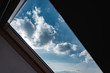 Attic. View from the window. View of the sky from the window. Skylight. Light in the house