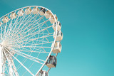 Fototapeta  - Big city ferris wheel on a background of clean blue sky