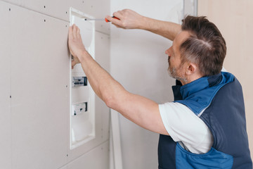 Sticker - Electrician attaching a cover on an electric board