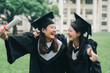 © PR Image Factory - Graduation asian female friends hold diploma. cheerful ladies students hugging shoulders arms with thumb up finger hand gesture best sign. beautiful cheerful women students looking each other smiling