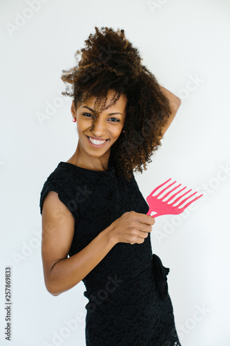 Funny Afro Hairstyle Woman Using Comb For Untangle Her Curly