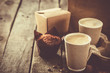 Coffee to go with muffin on wood background, copy space