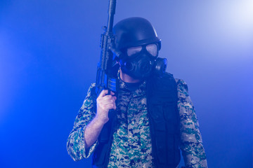 Soldier holding assault rifle in smoky haze