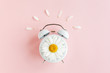 Composition-summer time from clock and chamomile flowers on pink background. Flat lay, top view 