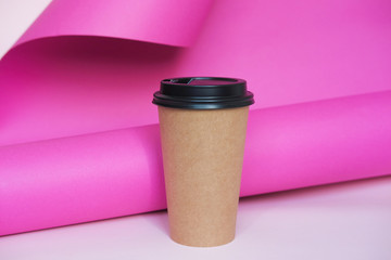 Wall Mural - Coffee cup on pink paper background. A couple of paper cups of coffee to take away.