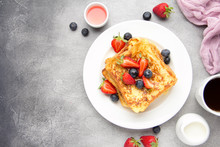 French Toast With Berries (blueberries, Strawberries) And Sauce, Traditional Sweet Dessert Of Bread With Egg And Milk. Morning Baking Food