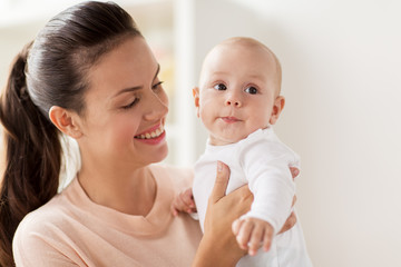 family, motherhood and people concept - happy mother with little baby boy at home