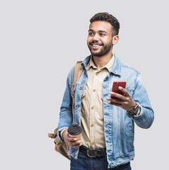 young handsome men with backpack holding smart phone and coffee. smiling student man going on a trav