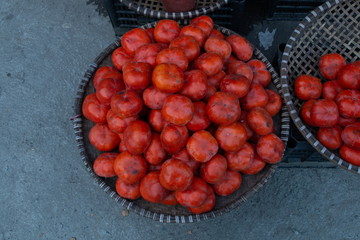 pile of red freshness tomatoes in tray at market