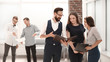 © yurolaitsalbert - employees discussing working documents, standing in the office lobby