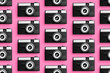 © Westend61 - Plastic photo cameras organized in a row over pink background
