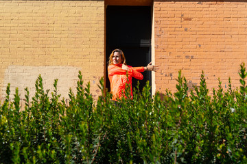 Wall Mural - Mature woman performing stretching exercises on her arms before training.