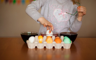 Happy easter. Little girl painter painted eggs. Kid preparing for Easter. Painted hand. Art and craft concept. Traditional spring holiday food