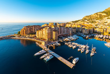 View Of Fontvieille Harbor With Cityscape At Sunrise
