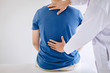 © Ngampol - Doctor physiotherapist treating lower back pain patient after exercising