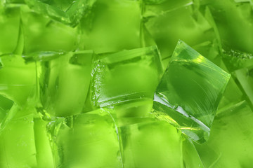 Green jelly cubes as background, closeup view