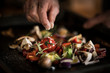© Westend61 - Hand seasoning vegetables on a baking tray