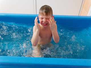 baby boy is taking a bath with bubbles. Jacuzzi bubble bath procedure.