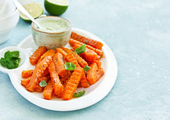 Canvas Print - Baked spiced pumpkin slices with avocado sauce. shooting from above.