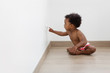 © Lisa Tichané - Baby sitting on the floor touching electrical plug