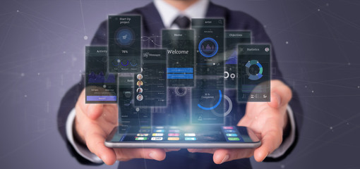 Wall Mural - businessman holding user interface screens with icon, stats and data 3d rendering