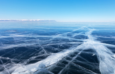 typical winter landscape of frozen lake baikal. endless fields of smooth blue ice with cracks recedi