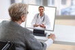 © JPC-PROD - disabled Senior woman consults a e-health doctor with tablet computer sitting on wheelchair . In touchscreen, male doctor: