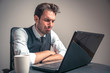 © Teodor Lazarev - Crying sad business man receiving terrible news over his laptop, reading mail containing financial loss report