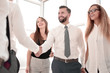 © ASDF - business people shake hands standing in the office