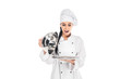 © LIGHTFIELD STUDIOS - Shocked chef in hat holding tray with cloche isolated on white