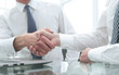 © ASDF - close up.colleagues shaking hands over a Desk