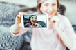© Svyatoslav Lypynskyy - Beautiful middle aged woman in casual clothes is making selfie