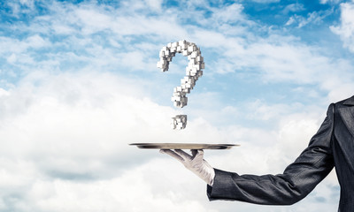 Wall Mural - Hand of waiter presenting question mark on tray.