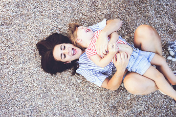 Wall Mural - Mom and daughter having fun together in a park