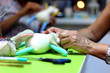 Hands of women creating a handmade soft toy of unicorn