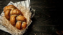 Traditional Jewish Bread Brown Challah On Wooden Background. Rustic Concept. Close Up