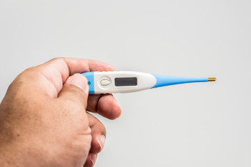 Hand holding the thermometer on white screen isolated