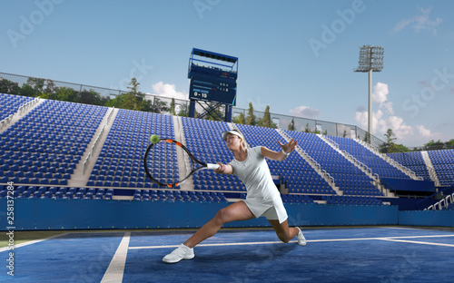 Beautiful female tennis player serving outdoor on professional tennis court.