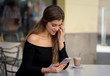 © SB Arts Media - Attractive young woman checking mobile phone happy having lots of followers on her online blog
