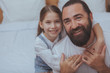 © mad_production - Close up of a happy single father and his cute little daughter smiling to the camera. Lovely little girl embracing her dad, smiling joyfully, copy space
