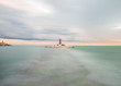 view of a lighthouse on a cloudy day in long exposure