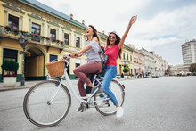 Two Beautiful Women Shopping On Bike In The City