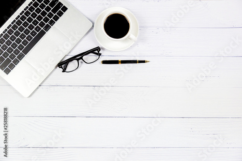 Photographie  Workspace in office , Wooden White desk with blank notebook and other office supplies,Top view with copy space