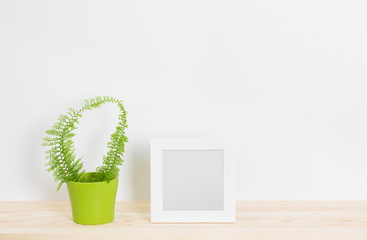 Wall Mural - White picture frame and fern in green pot