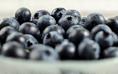 Wall Mural - Blueberries in small bowl, closeup detailed photo