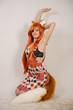 sexual hot slim redhead anime girl posing as little fox with furry ears and fluffy long tail alone on white background