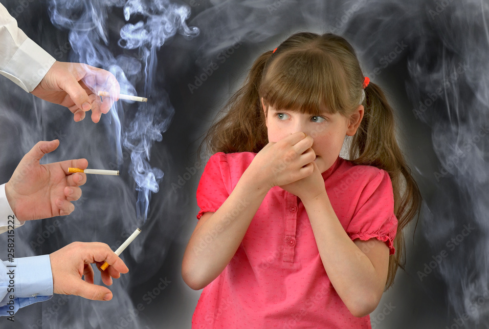 parents smoke in front of the child, kid, breathes tobacco smoke.Smoking  ,bad habit, conceptual photography. Stock Photo