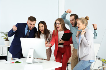 Wall Mural - Group of office employees celebrating victory at workplace