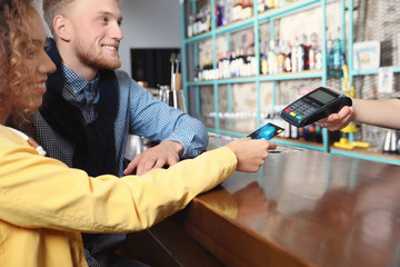 Sticker - Clients using credit card machine for non cash payment in cafe